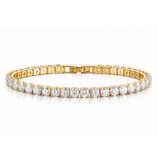 Pulsera tipo tennis en tono dorado con una fila de zirconias redondas transparentes, presentada en forma ovalada sobre fondo blanco.